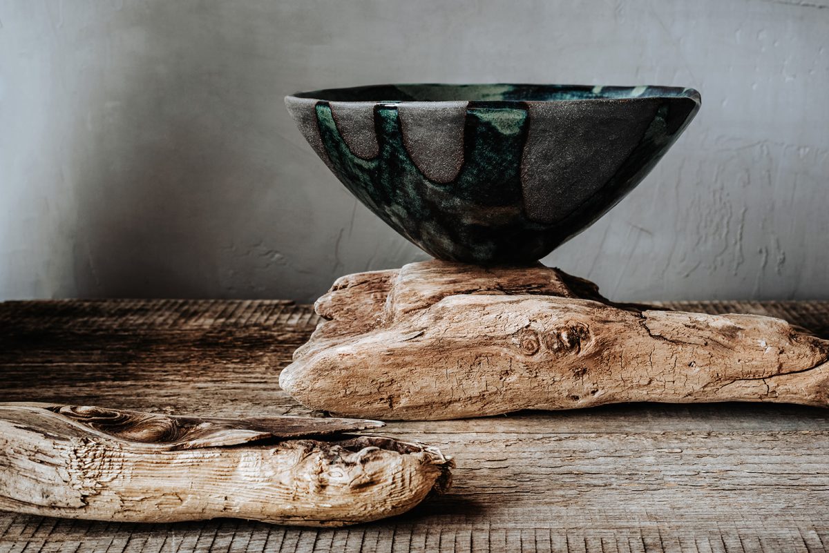 Handmade ceramics in the style of wabi sabi. Grey clay bowl with an abstract green pattern.